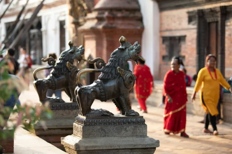 Kathmandu, Nepal: City of Ancient Temples and Prayer Wheels 3 Bronze lion statues at a temple courtyard in Kathmandu, Nepal, with vibrant cultural surroundings reflecting Nepalese traditions