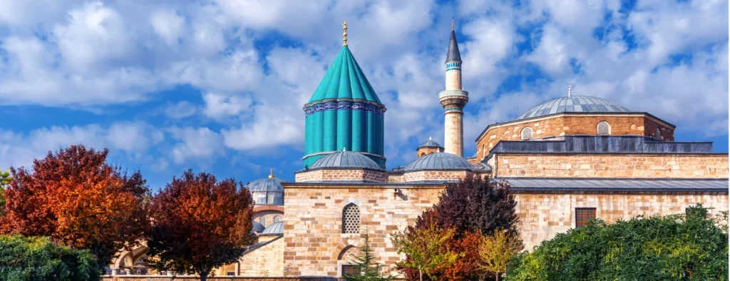 Majestic tomb of Rumi in Konya, Turkey, surrounded by vibrant turquoise tiles and Islamic calligraphy, symbolizing Sufi spirituality and the poet's legacy