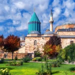 Majestic tomb of Rumi in Konya, Turkey, surrounded by vibrant turquoise tiles and Islamic calligraphy, symbolizing Sufi spirituality and the poet's legacy
