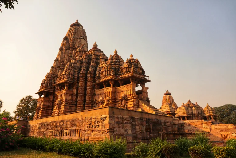 An enchanting view of one of the stunning temples in the Khajuraho temple complex, showcasing its intricate carvings, historic architecture, and spiritual ambiance
