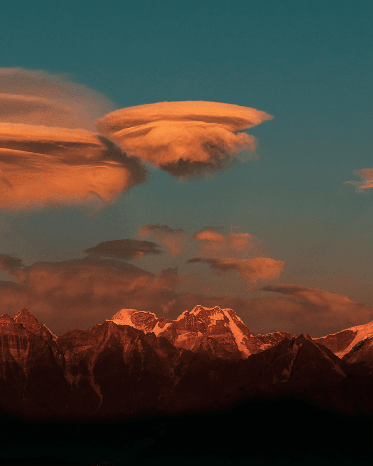 Pokhara, Nepal; The Pulse of Annapurna Region Trekking 4 Golden hues of sunset illuminating the Annapurna mountain range in Nepal, creating a mesmerizing view