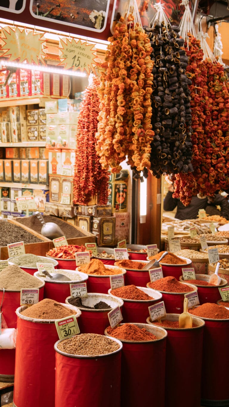 Istanbul, Türkiye 3 An antique spice shop in Istanbul's bustling Grand Bazaar, showcasing a vibrant array of colorful spices, herbs, and teas in traditional sacks and jars, capturing the essence of Ottoman trade culture and aromatic history
