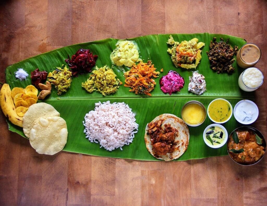 lots of Indian food on banana leaves.