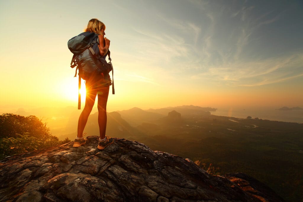 A solo traveler in mountains with a beautiful view